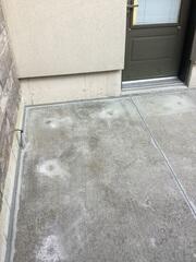 The area around this side entrance was precisely leveled to match the surrounding concrete and foundation. Our watertight sealant protects the foundation from moisture while giving the walkway a modern appearance.