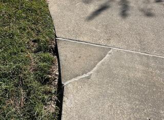 Driveway After Image 1, the concrete section was reconnected, sealed, and leveled.