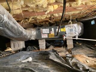 Crawl Space in need of encapsulation and supplemental beams to support the floors above.