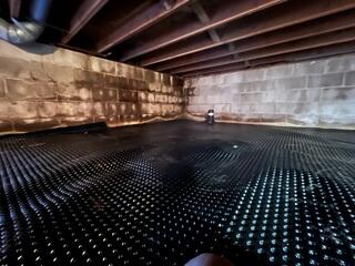 During: Our Foreman, Jesus, and his crew laid Drainage Matting and attached CleanSpace to the crawl space.