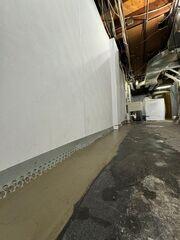 We installed our WaterGuard Drainage System to capture water seepage at its point of entry before it could spread across the basement floor.