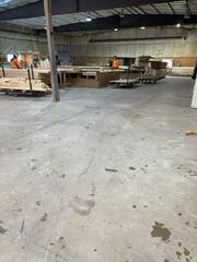 In a busy truss manufacturing facility, a level floor is essential for safety and efficiency. These long, linear cracks show where the slab has lost support, disrupting daily operations and creating a dusty, uneven work environment.