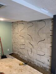 Before: Our Design Specialist, Ryan, recommended securing waterproofing and foundation repair products throughout the struggling basement.