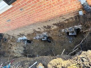 This photo was taken after we screwed all three piers straight down underneath the home and attached our brackets to transfer the weight of the home.