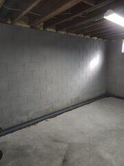 During: Our Foreman, Lane, and his crew secured WaterGuard around the basement perimeter.