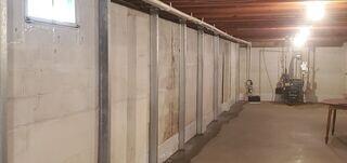 PowerBraces installed along the  wall, reinforcing the cracked foundation and stabilizing the wall against further movement.