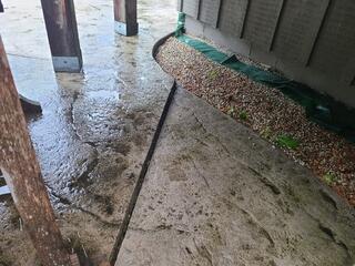 This angle shows the severity of the tilt near the backyard. As the slabs sank, they began to slope toward the home's foundation and structural rock tiers. Without leveling, rain and snowmelt would be directed straight toward the house, risking long-term structural damage and making the patio area virtually unusable for outdoor furniture.