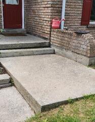 The overhead view shows the strategic access points drilled into the concrete. These small ports allow the structural polymer to be injected into the hollow cavities, ensuring a controlled and even lift of the heavy slab.