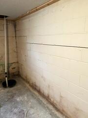 Before: Our Design Specialist, Dylan, recommended waterproofing and stabilizing the struggling walls.