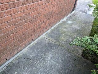 A clear look at the walkway after our team completed the restoration. The photo shows the slabs successfully lifted and stabilized, eliminating the dangerous vertical offsets that once acted as a trip hazard. By filling the gaps and leveling the concrete, we've removed the openings where rainwater used to wash out the soil, ensuring the walkway now has the solid support it needs to stay in place.