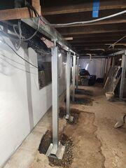 SmartJacks were adjusted to the height of the basement and tightened to secure any weakened beams.