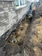 During: Our Foreman, Victor, and his crew secured the Helical Piers below the foundation.