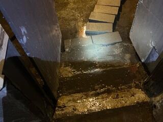 Water trickling down the stairs into the basement