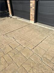 A clear look at the dangerous ledge created when this stamped driveway settled away from the garage entrance.