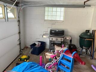 This photo shows the cracked garage wall. Cracks that form in a stair-like fashion like this are often a result of foundation settlement. This window was the structurally weakest point in the wall, which was the crack ran to the corner of it.