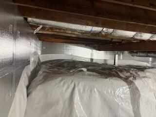 This photo shows the rest of the newly transformed space. Concealed underneath the white vapor barrier on the floor is our drainage matting, which acts as a barrier between the white CleanSpace and the dirt ground.