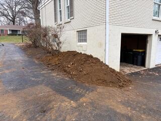 This picture shows after we backfilled the trench with soil to conceal the foundation repair system.