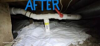 Purple Mountain Radon installed a RadonWell (where the pipe goes vertically below the soil) and connected it to the sub-slab suction point (to the right of the valve).