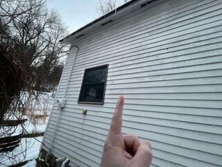 Before: Our Design Specialist, Justin, recommended securing a Radon Mitigation System outside the home.