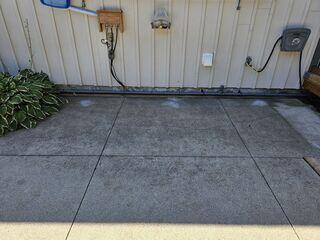 The "After" shot of the utility area. These slabs are now flush with the wall and the surrounding deck, creating a seamless, trip-free path to the pool equipment.