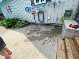 A clear look at the problem area. You can see the significant gap and uneven pitch between the pool shed and the concrete slabs where the ground has settled.
