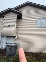 Before: Our Design Specialist, Romeo, recommended securing a Radon Mitigation System outside the home.