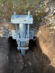 The installation of the Bracket and Push Pier, attached to the foundation wall.