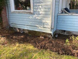 Three successfully installed brackets, and Push Piers, filled over with dirt. Job complete!