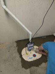 Installer installing Triple Safe Sump Pump