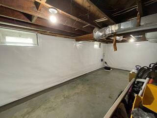 CleanSpace wall vapor barrier seals the foundation walls, eliminating moisture, improving air quality, and giving the basement a clean, dry finish.