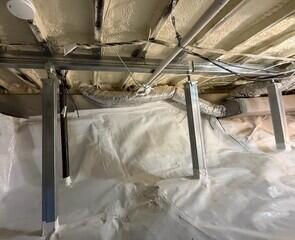 Now this crawl space is not only insulated and encapsulated, it's also supporting the home above with our SmartJack Stabilizing System.