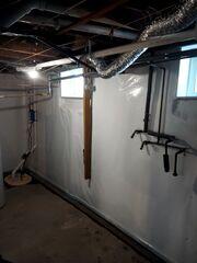 During: Our waterproofing crew worked hard to secure the waterproofing products throughout the basement.