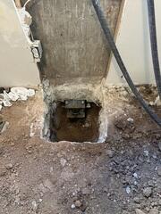 Push pier installed beneath the foundation footing in Clearfield, Utah to stabilize structural settlement. Additional pier depth was required to reach stable load-bearing soil.