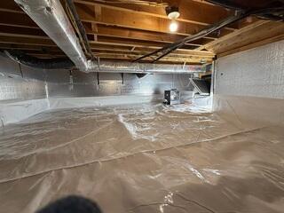 Fully encapsulated crawl space with CleanSpace vapor barrier, SilverGlo insulation, and SaniDry Sedona dehumidifier creating a clean, dry, and healthy environment.