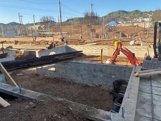 New concrete stem walls and anchor bolts installed during Pacific Palisades fire rebuild project.