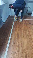 To access the crawl space for the encapsulation, the crew taped off an area of the living room and got to work removing the floor and subfloor.