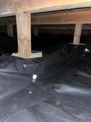 Underneath the 6 Mil Black Plastic Vapor Barrier, lies all the piping we installed to collect all water intrusion. The pipes route the water to the SuperSump, and then the pump sends all water safely away from the home via a buried discharge line.