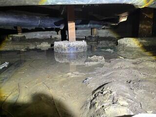 Excessive standing water in the crawl space, threatening the stability of the home.