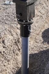 Installation of a production helical pier using a high-torque hydraulic drive system. The pier advances through liquefiable fine-grained silt clays to reach stable load-bearing strata beneath the structure.