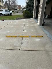 During: Our Foreman, Ryan, and his crew lifted the slabs back to their original level.