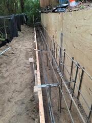 Placement of heavy-duty rebar to provide strength to the Retaining Wall.