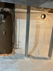 To address the moisture problem, we installed a full CleanSpace encapsulation system. This included a durable vapor barrier applied across the ground and along the crawl space walls, effectively sealing the area from moisture in the soil. A drainage solution was also implemented to manage any water entering the space and direct it away from the home.

To restore proper support, we installed a SmartJack system beneath the affected areas of the home.