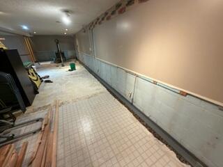 The crew removed the tile and drywall to waterproof the finished side of the basement as well.