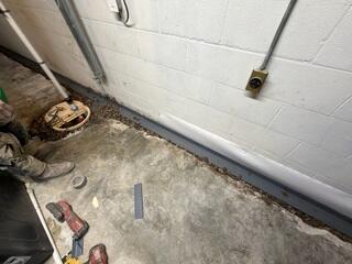 In this area, the crew dug a new sump pit and installed the TripleSafe sump liner & sump pump. They also installed WaterGuard along the perimeter.