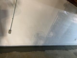 This is what the WaterGuard subfloor drains looked like once we applied a thick concrete layer over them.