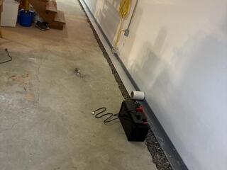 We made sure to properly pitch and grade our WaterGuard drains so all the water flows down into the sump pump. The tape you see rolled across the top of the gutter drains makes concealing the drains with concrete easier and better.