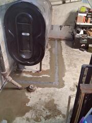 WaterGuard® Interior Drainage System installed along the perimeter to intercept incoming water at the foundation
TrenchDrain™ System installed around the oil tank to capture surface water in the problem area