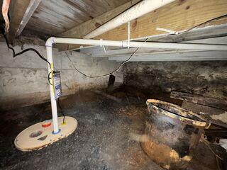 Sump Pump System installed to collect and remove water from the crawl space