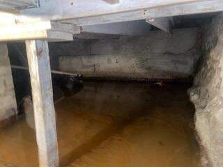 The flooded crawl space in Brownington, Vermont, needed a solution for water entering it.