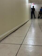 Slab settlement of floor slab below interior wall.